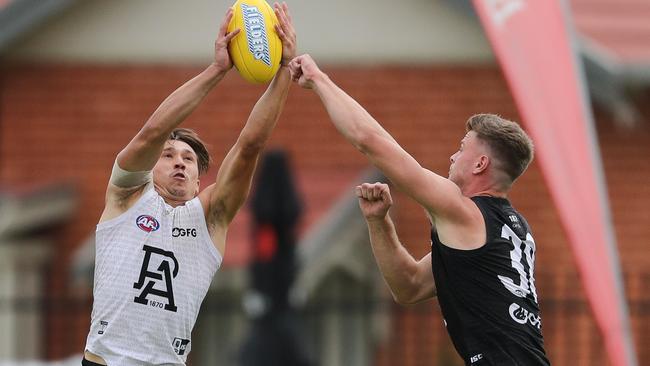 STRONG MARK: Tobin Cox marks well opposed to ruckman Peter Ladhams during Port Adelaide’s internal trial at Alberton Oval. Picture: MATT TURNER (AFL Photos via Getty Images).