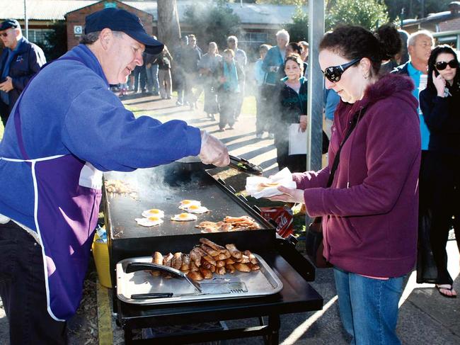 Hungry voters at a sausage sizzle. Picture: Robert McKell