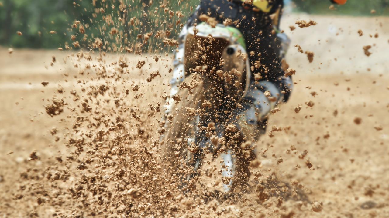 General, generic stock photo of mud debris flying from a rear tyre of a trail bike during a motocross dirt bike race. Photo: iStock – Getty Images.