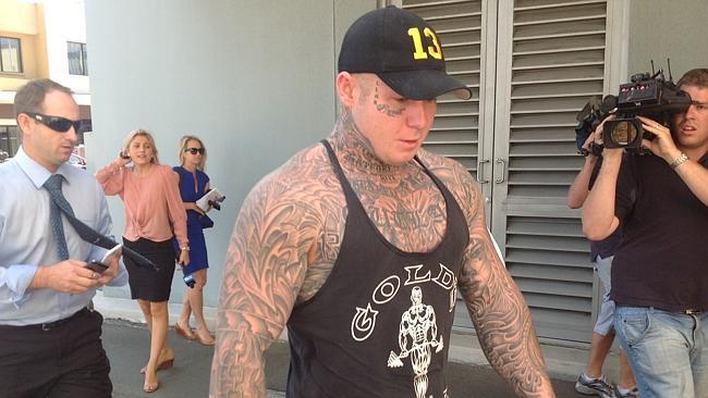 Accused Bandido bikie brawler Richy Chapman is led into Southport Watchhouse.