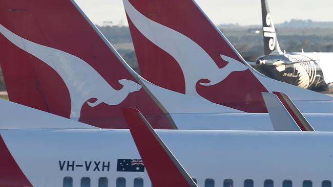 A worker checks the wings for ice. Qantas planes, Melbourne airport. Melbourne has shivered through a cold Winter's morning. Picture: Nicole Garmston