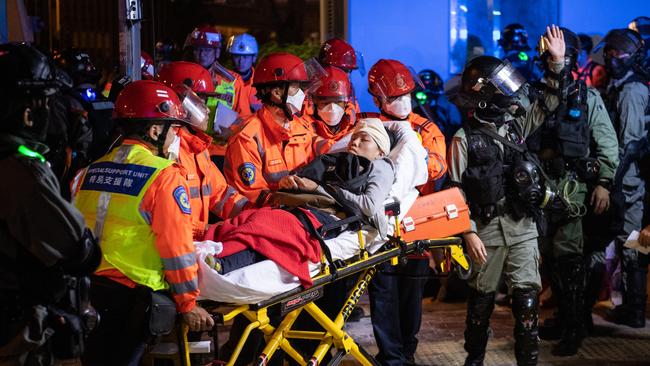 Injured people are taken away after clashes between anti-government protesters and police at Hong Kong Polytechnic University. Picture: Getty Images