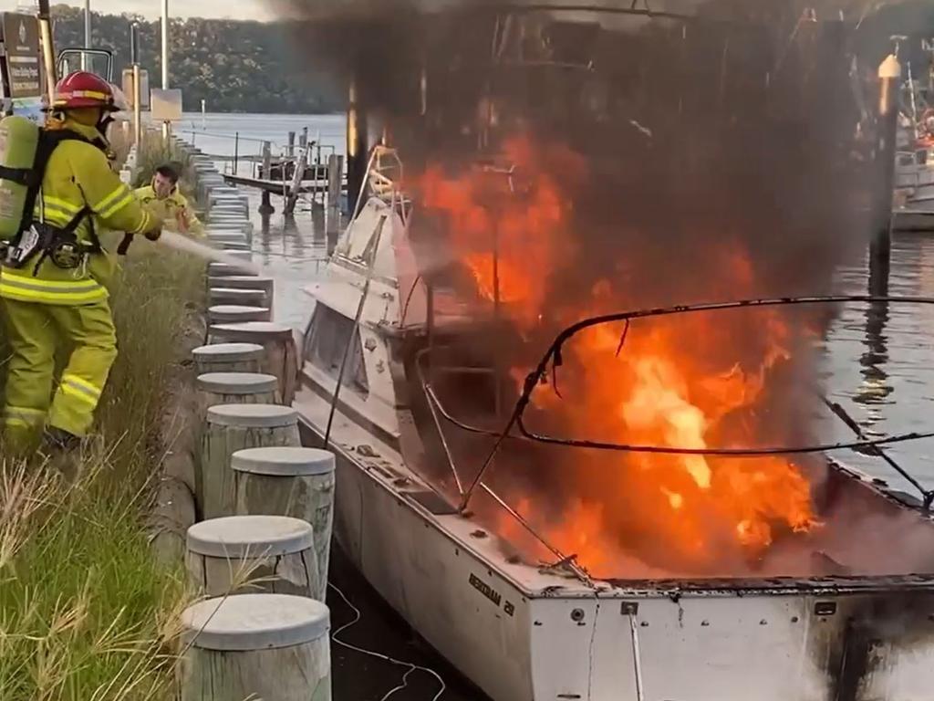 Up to eight people were taken to hospital with burns when a 28 foot cruiser exploded into flames at Brooklyn Marina on the Hawkesbury River today. Picture: Greg Manning.