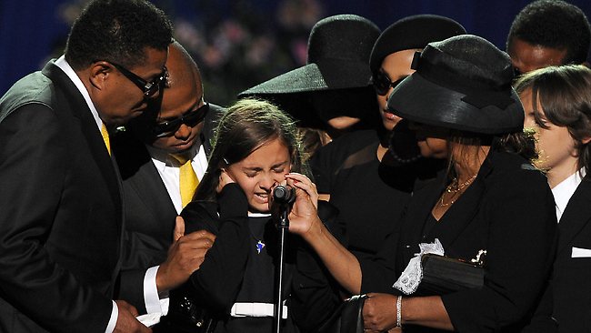 Michael Jackson's daughter Paris Michael Katherine (C) is comforted by family members at the Michael Jackson public memorial service held at Staples Center on July 7, 2009 in Los Angeles, California.