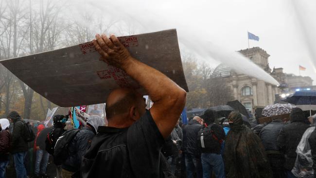 Berlin police use a water cannon to disperse protesters demonstrating against measures imposed by the German government to limit the spread of coronavirus. Picture: AFP