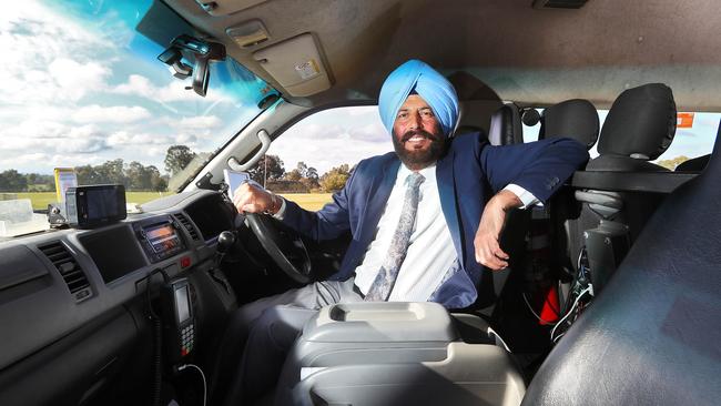 Taxi driver Lakhwinder Singh Dhillon with his cab near his home in Thomastown, says ‘Scott Morrison is doing really well’. Picture: Aaron Francis