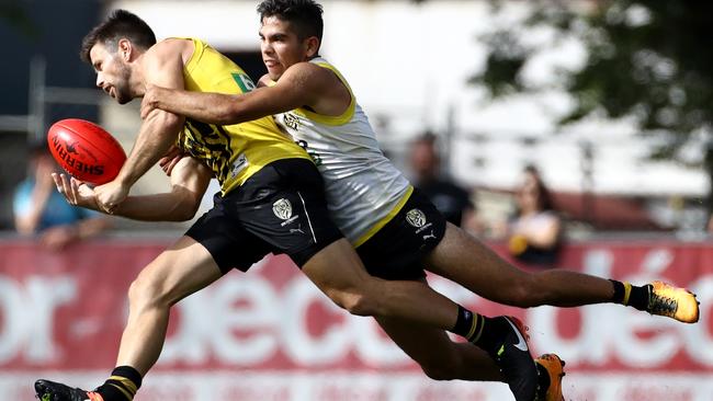 Rookie Tyson Stengle runs down Trent Cotchin. Picture: Mark Dadswell