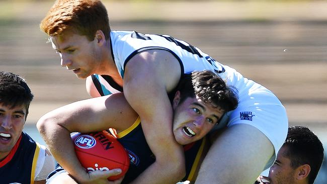 Ned McHenry is tackled by Port’s Willem Drew during 2019’s under 23 trial Showdown. Picture: AAP/Mark Brake.