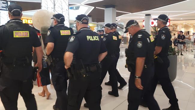 A heavy police presence follows Aboriginal protesters through Australia Fair. Photo: Brianna Morris-Grant