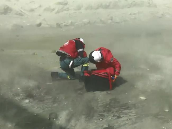 Rescuers arrive on White Island after the volcano eruption. Picture: Auckland Rescue Helicopter Trust