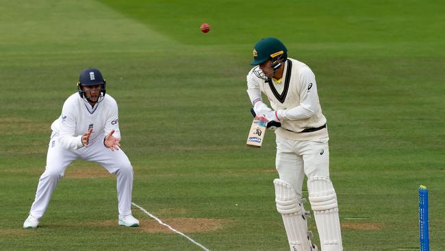 England's Joe Root (L) prepares to take a catch and dismiss Alex Carey. Picture: AFP