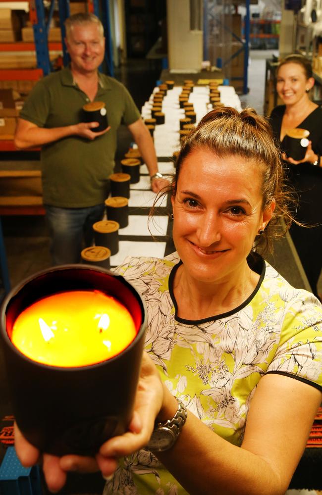 Sandra Klaric, owner of Arundel based candle shop Lanterncove, with staff members Justin Holst and Melanie Pietrobon showing off the 'tobacco vanilla' candle. Picture Glenn Hampson