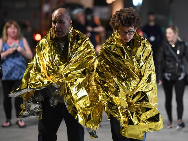 Members of the public, wrapped in emergency blankets leave the scene of a terror attack on London Bridge in central London. Picture: AFP