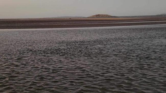 A dugong (seen in the distance here to the left of the island) washed up on Kinka Beach, Yeppoon, on August 20. Photos Darryn Nufer.