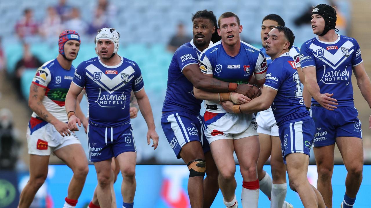 SYDNEY, AUSTRALIA - JULY 02: Jack Hetherington of the Knights tussles with Jayden Okunbor of the Bulldogs during the round 18 NRL match between Canterbury Bulldogs and Newcastle Knights at Accor Stadium on July 02, 2023 in Sydney, Australia. (Photo by Jeremy Ng/Getty Images)