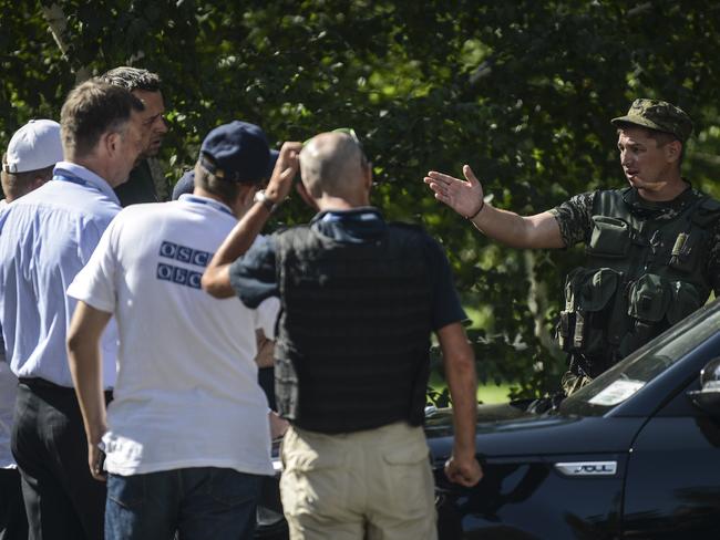 Deputy Chief Monitor of the Organization for Security and Cooperation in Europe (OSCE) Special Monitoring Mission to Ukraine, Alexander Hug (2nd L), and fellow OSCE members listen to a separatist in Donetsk. Picture: Bulent Kilic