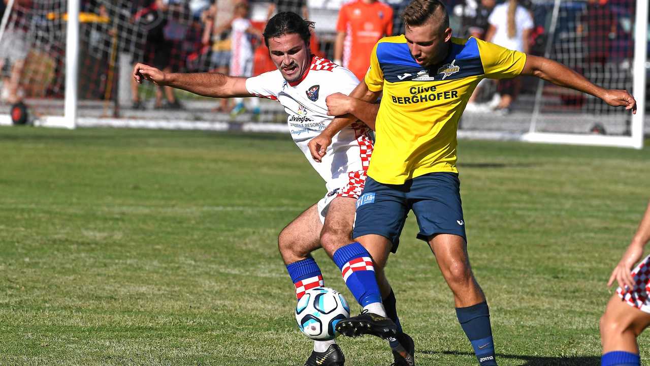 TIGHT BATTLE: Gold Coast Knights player Oskar Dillon (left) battles for possession of the ball with South West Queensland Thunder striker Anthony Grant. Picture: GCB - John Gass