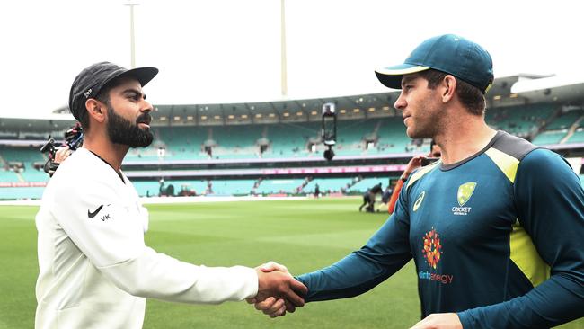 Indian captain Virat Kohli shakes hands with Australian captain Tim Paine after play was called off due to the weather at the SCG, India winning the series 2-1. Picture. Phil Hillyard