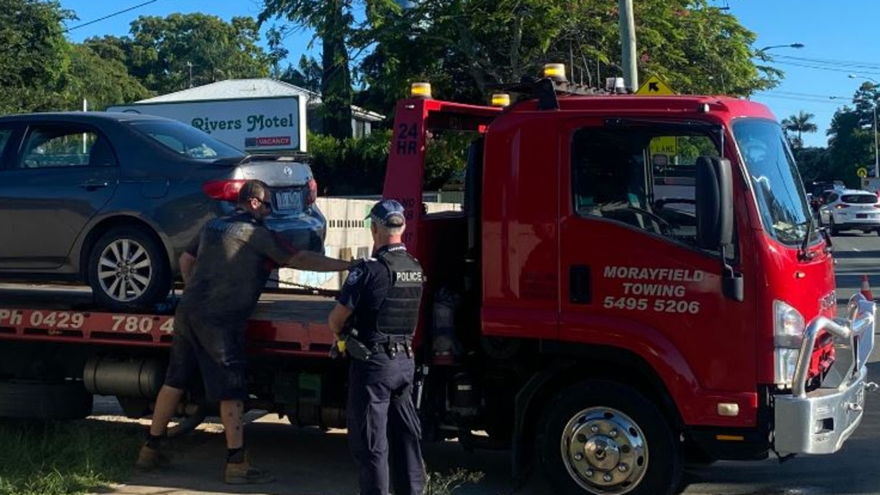 A car is towed away from the scene at a hotel where a man's body was found overnight. Picture: Samantha Scott