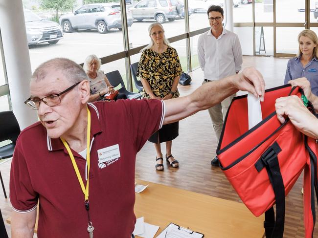 Returning Office for the seat of Aspley Tom Freeman draws the voting ballot order at Carseldine with candidates Fiona Hawkins (Greens, Bart Hellish (ALP) and Amanda Cooper (LNP) present on Tuesday. Picture Lachie Millard