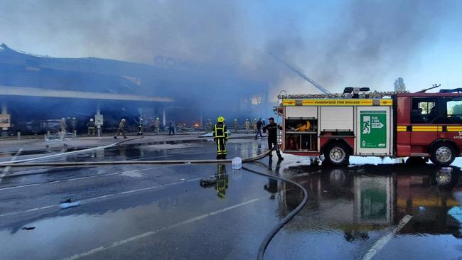 Firefighters putting out the fire in a mall hit by a Russian missile strike in the eastern Ukrainian city of Kremenchuk. Picture: AFP