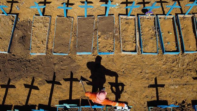 A gravedigger standing at the Nossa Senhora Aparecida cemetery where COVID-19 victims are buried in Manaus, Brazil, in June. Picture: AFP