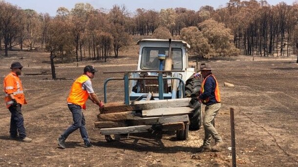 Post men: BlazeAid volunteers rebuild fences at Adelong as part of a project that will dwarf the Black Saturday repair works. 