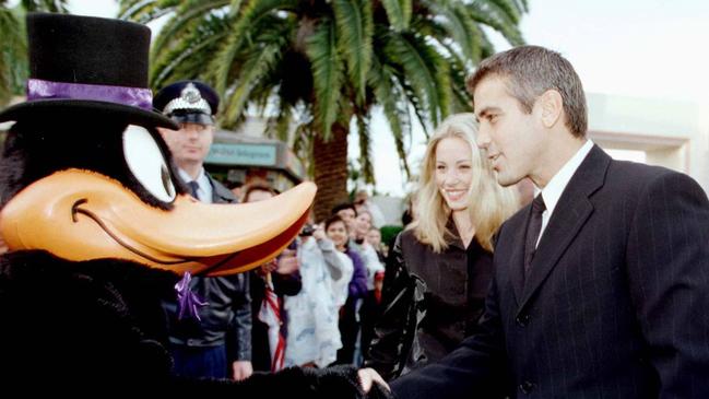 Actor George Clooney &amp; girlfriend Celine Balitran meet cartoon character Daffy Duck at Movie World.