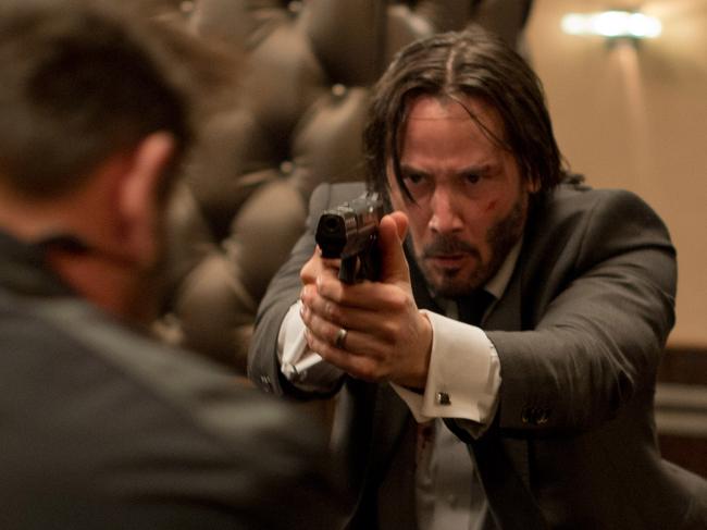 This photo released by Lionsgate shows Keanu Reeves, center, as John Wick in a scene from the film, "John Wick." (AP Photo/Lionsgate, David Lee)