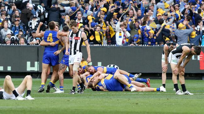 Collingwood players looked defeated on the final siren as the Eagles players celebrated. Picture: David Caird