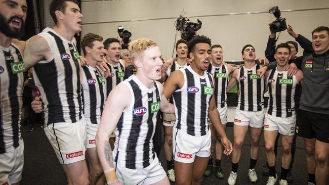 John Noble and Isaac Quaynor celebrate their first win as Collingwood players after the Round 17 match against West Coast Eagles. Picture: AAP Image/Tony McDonough