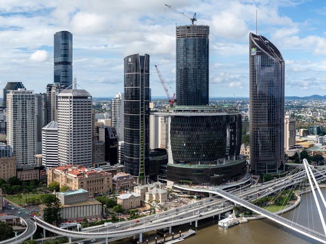 Developing Queensland - Discover the dramatic aerial view of the financial district skyscrapers and Brisbane River in Queensland, Brisbane, Australia, during summer. The stunning skyline and winding river create a picturesque urban landscape perfect for business and leisure.