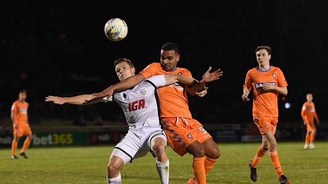 Scott Galloway of Adelaide United (left) competes with Jean Carlos Solorzano Madrigal of the Lions during the FFA Cup Round of 16 match between Lions FC and Adelaide United at Perry Park in Brisbane, Wednesday, August 29, 2018. (AAP Image/Dave Hunt)