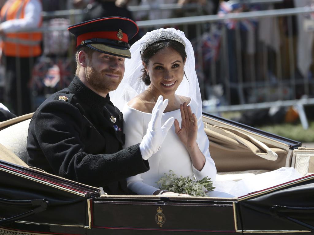 Britain's Prince Harry and Meghan Markle ride in an open-topped carriage after their wedding ceremony in May 2018. Picture: AP