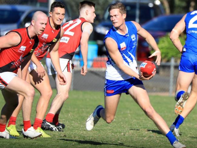 Liam Jeffs looks to dish off a handball. Picture: Field of View Sports Photography