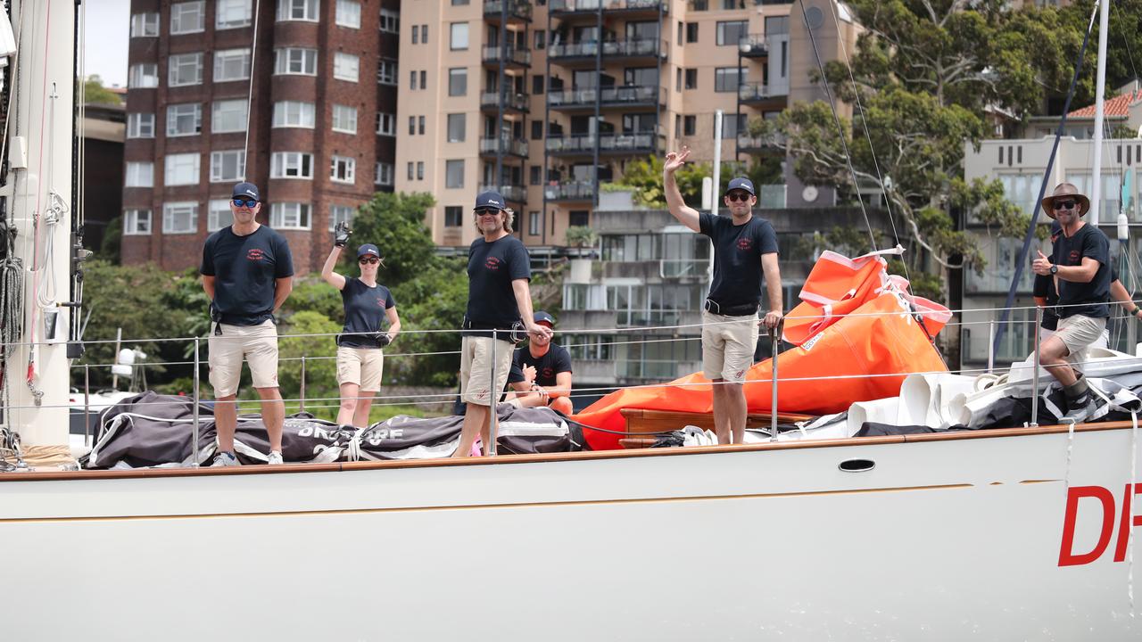 Crews wave as they head for the start line. Picture: Richard Dobson