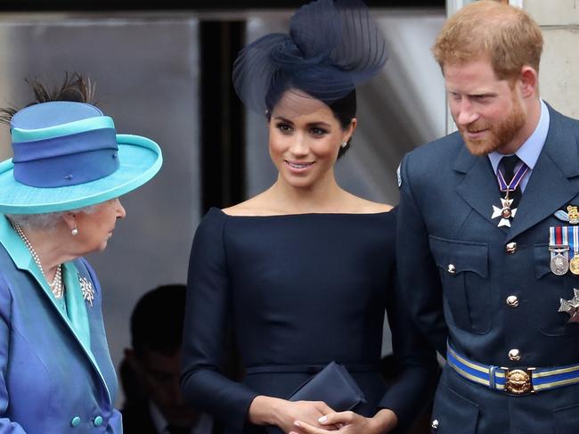 (FILE PHOTO) Prince Harry, Duke of Sussex and Meghan, Duchess Of Sussex have announced they are to step back as Senior Royals and say they want to divide their time between the UK and North America. LONDON, ENGLAND - JULY 10:  (L-R)  Queen Elizabeth II, Meghan, Duchess of Sussex, Prince Harry, Duke of Sussex watch the RAF flypast on the balcony of Buckingham Palace, as members of the Royal Family attend events to mark the centenary of the RAF on July 10, 2018 in London, England.  (Photo by Chris Jackson/Getty Images)