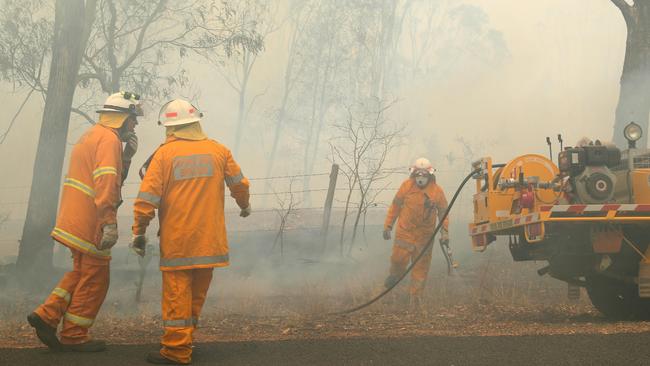 Rural Fire Brigade fighting part of the Pechey bushfire at Mount Jockey Rd, Ravensbourne on Saturday. Picture: Liam Kidston.