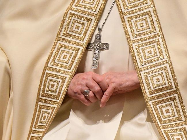 The hands and the cross of Pope Francis during the vespers at St Peter's basilica in The Vatican, on February 1, 2025. (Photo by Tiziana FABI / AFP)