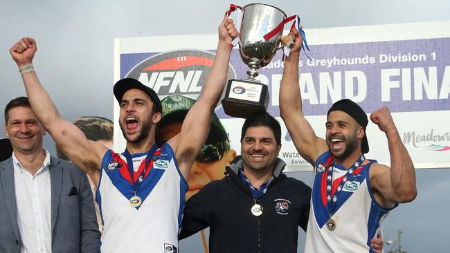 West Preston-Lakeside co-captains Nathan Valladares and Ahmed Saad lift the NFNL Division 1 premiership cup with coach Rob Maiorana (centre). Picture: Hamish Blair