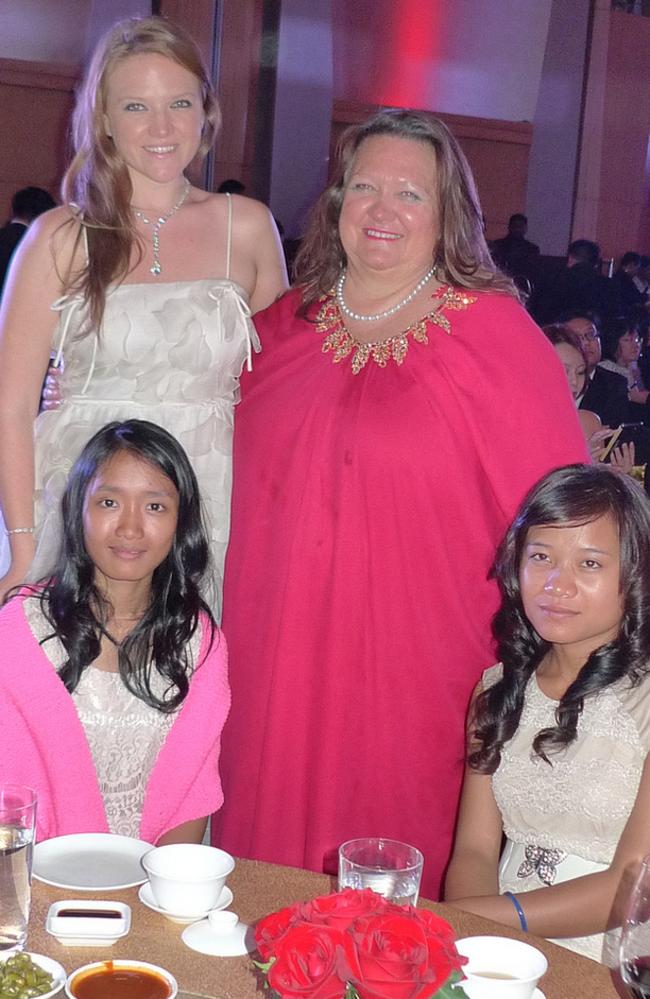 Gina Rinehart poses happily with two of her nine ‘Cambodian daughters’.