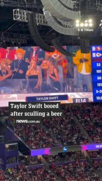 Taylor swift skols a beer at the Super Bowl