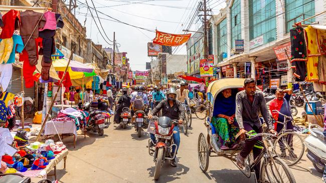 There are so many moving pieces in the tiny alleyway I can’t begin to take them all in. And yet somehow my rickshaw driver anticipates their every move.