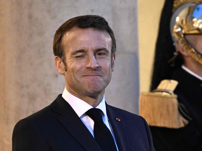 French President Emmanuel Macron reacts as he waits to greet Kazakh President at the Elysee Palace in Paris on November 29, 2022. (Photo by Emmanuel DUNAND / AFP)