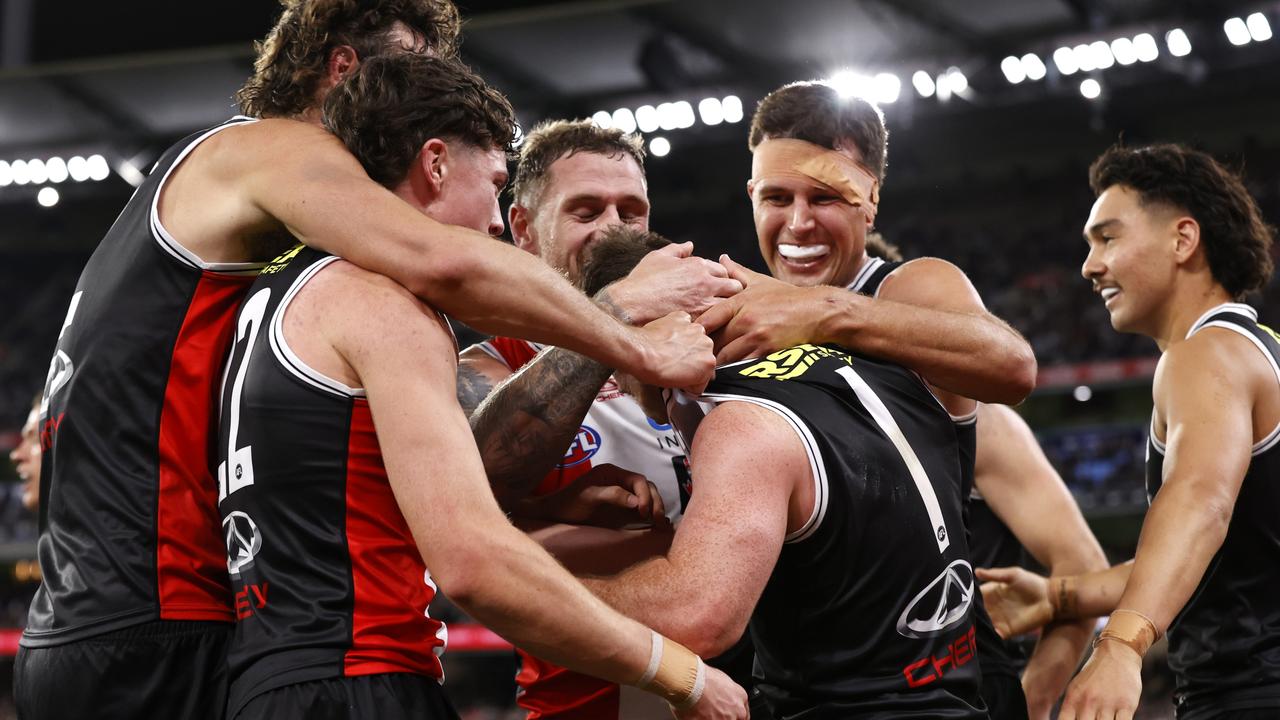 St Kilda players mob Jack Higgins after his contentious but brilliant goal that sealed the Saints’ victory over Collingwood on Thursday night. Picture: Darrian Traynor / Getty Images