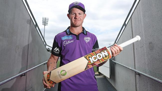 TRIBUTE: Hobart Hurricanes’ D'Arcy Short with a custom bat featuring artwork created by Cairns indigenous artist Marcus McGregor-Cassady. Picture: LUKE BOWDEN