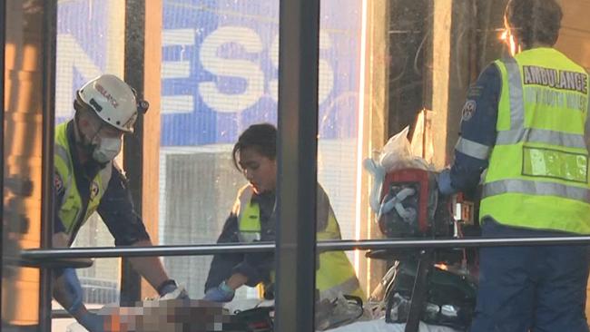 Emergency service workers assisting a woman who fell on the tracks at Punchbowl Station. Picture: TNV