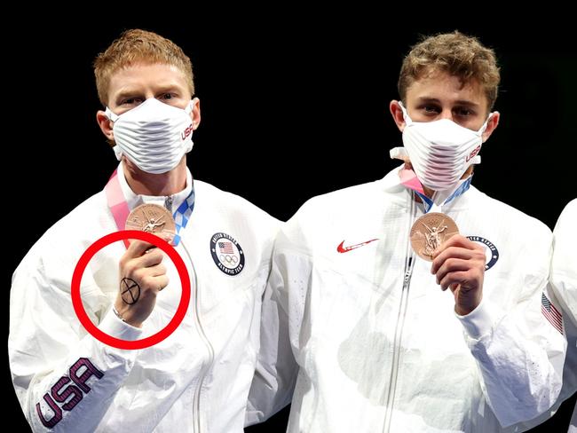 Race Imboden, left - CHIBA, JAPAN - AUGUST 01: Bronze medalists Team United States celebrate on the podium during the medal ceremony for the Men's Foil Team Team Fencing Gold Medal Match on day nine of the Tokyo 2020 Olympic Games at Makuhari Messe Hall on August 01, 2021 in Chiba, Japan. (Photo by Elsa/Getty Images)