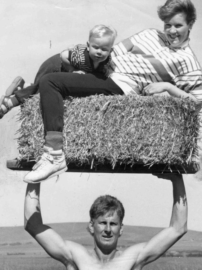 Alan lifting wife Robyn and son Dylan on hay bale at their farm in Koolunga in 1988.