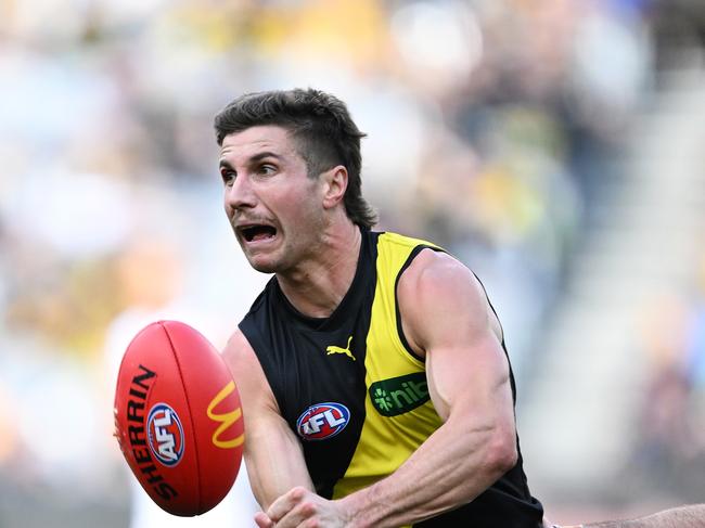 MELBOURNE, AUSTRALIA – MAY 05: Liam Baker of the Tigers handballs during the round eight AFL match between Richmond Tigers and Fremantle Dockers at Melbourne Cricket Ground, on May 05, 2024, in Melbourne, Australia. (Photo by Daniel Pockett/Getty Images)